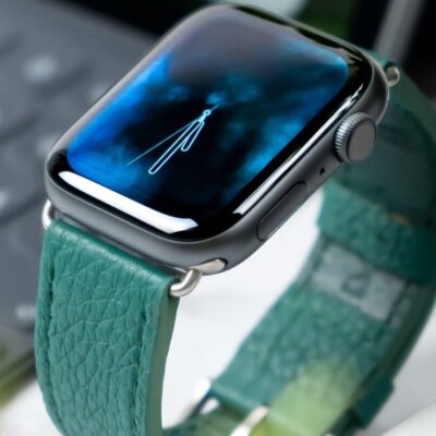 Apple Watch with teal leather band.