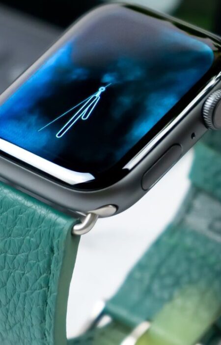 Apple Watch with teal leather band.