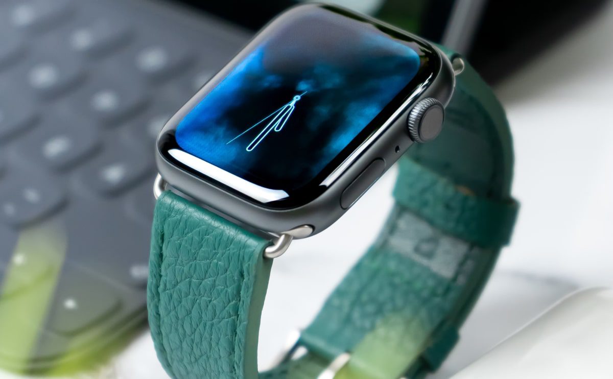 Apple Watch with teal leather band.