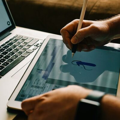 Person drawing on tablet with stylus.