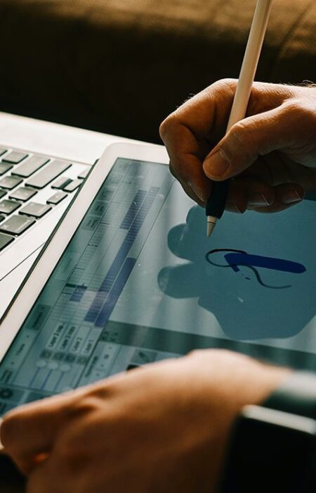 Person drawing on tablet with stylus.